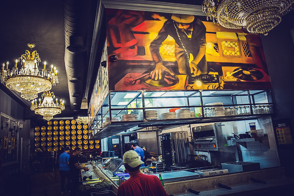 The inside of Beatstro showcases an open kitchen & murals. Photo courtesy of Beatstro.