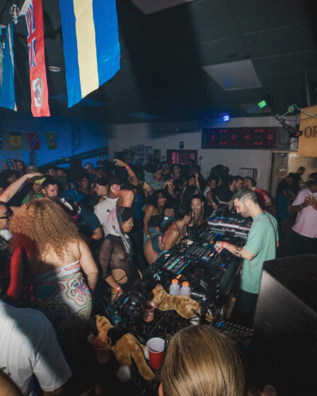 The DJ stands under a "Please Order Here" sign.